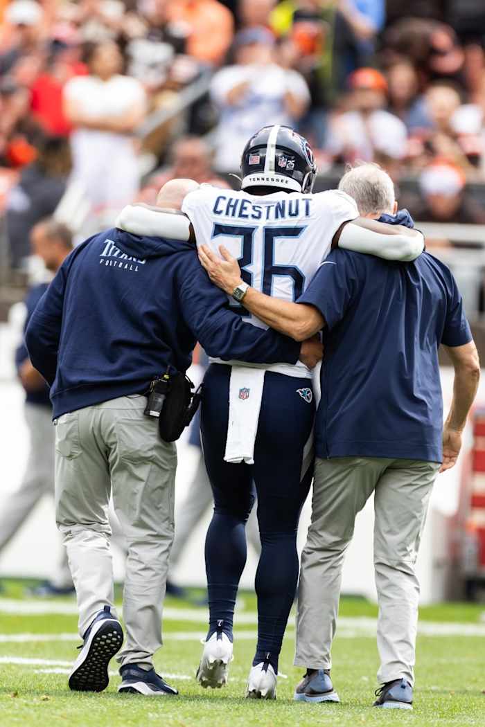 Tennessee Titans running back Julius Chestnut (36) gets help off the field from an injury during the first quarter against the Cleveland Browns at Cleveland Browns Stadium.